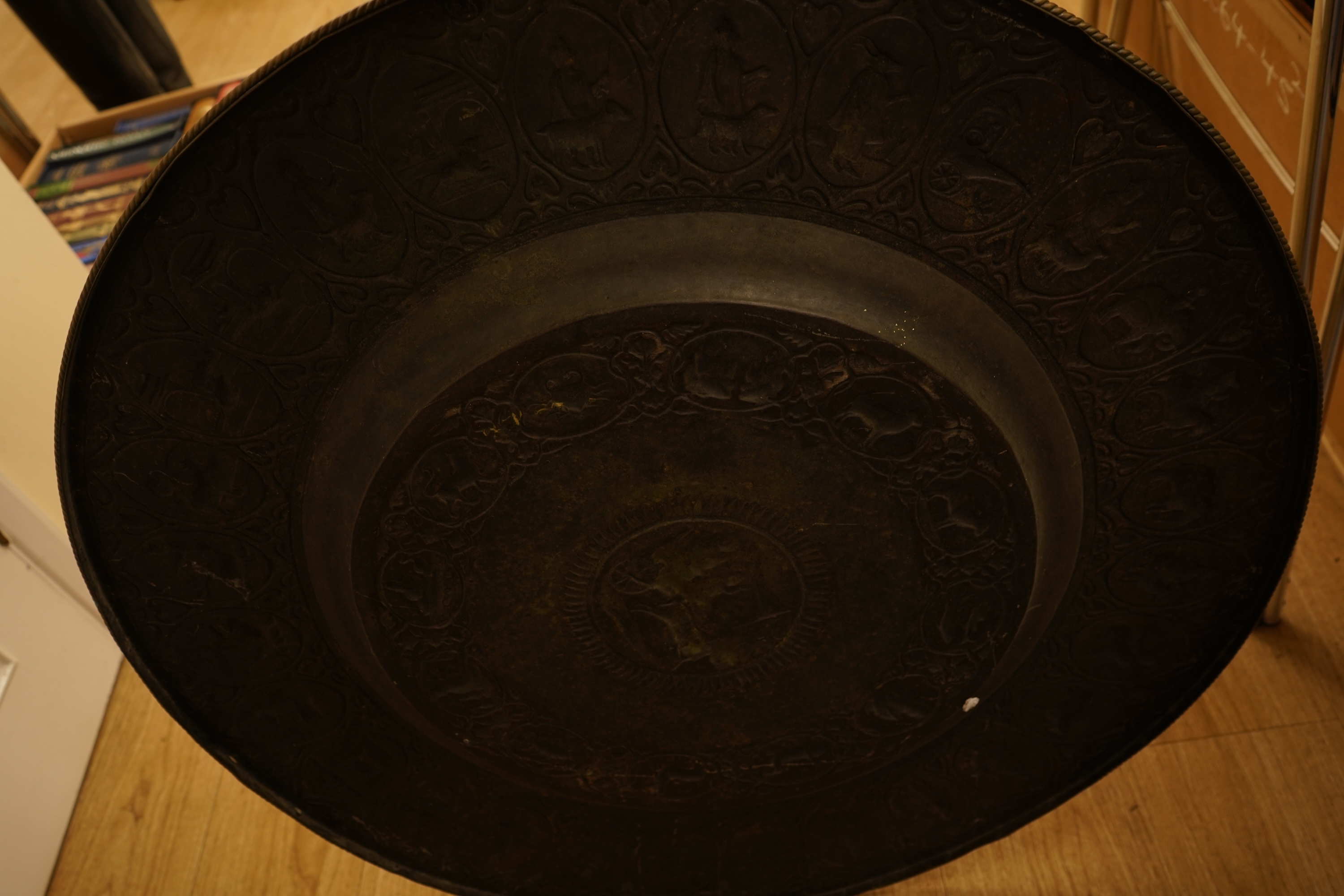 A large early 20th century Indian embossed brass tray, 78cm in diameter